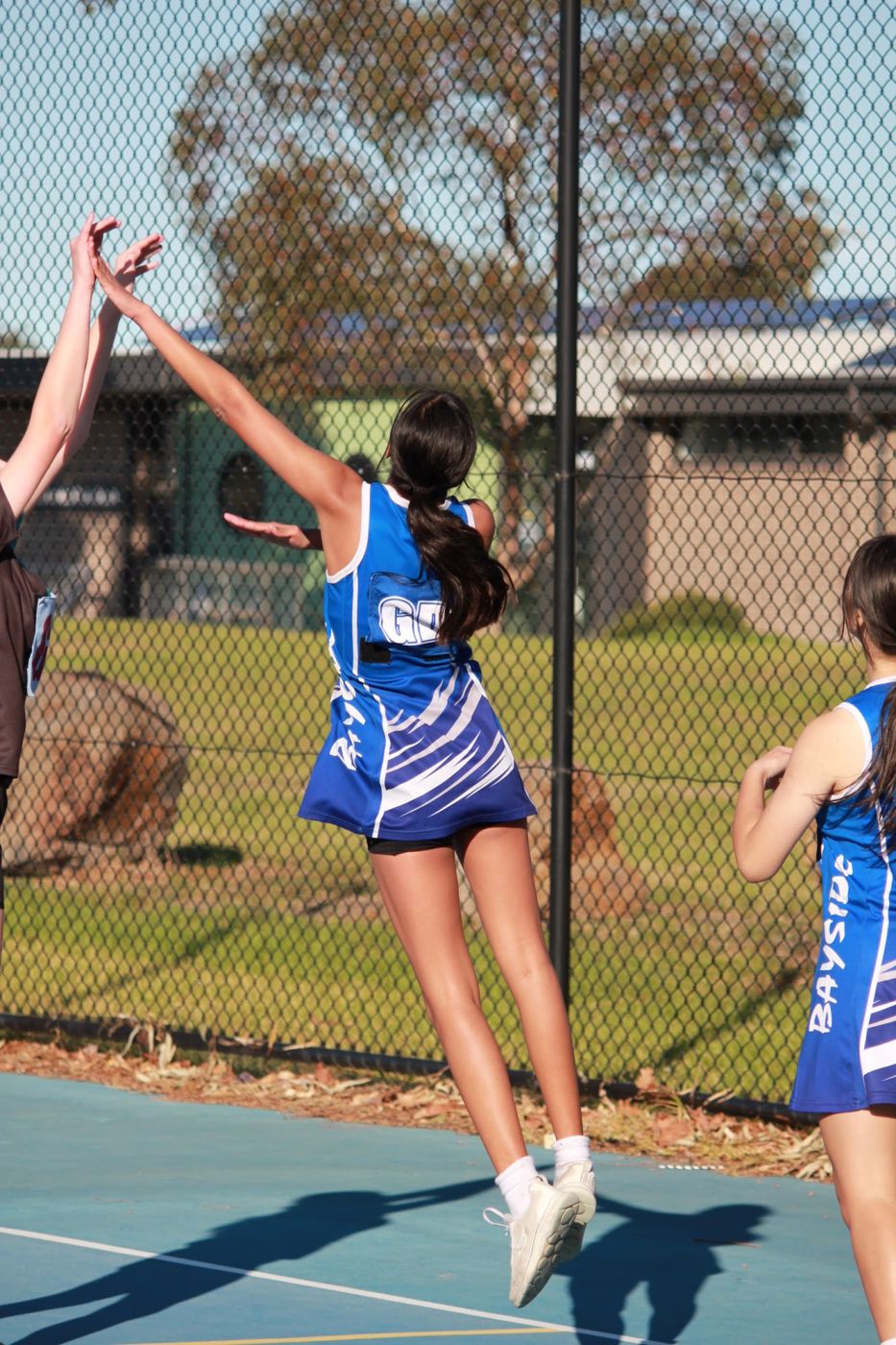 A Bayside player leaping for the ball